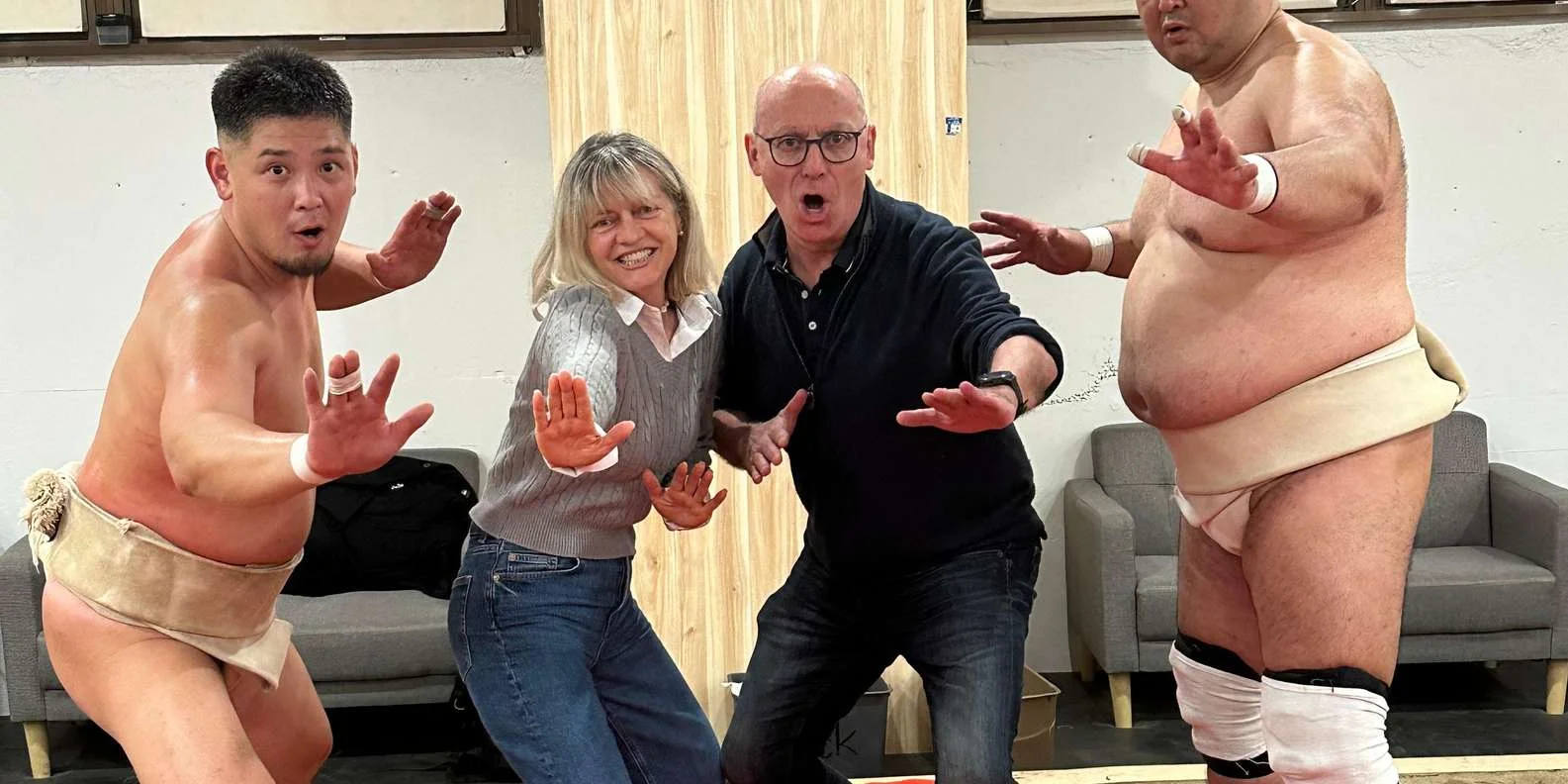 Best sumo experience in Japan - happy tourists at Shinjuku interactive sumo show Tokyo